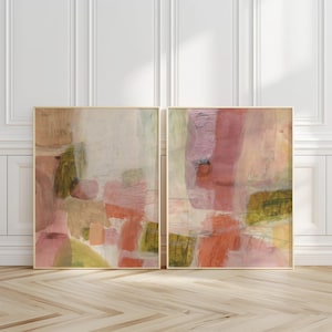 May include: A set of two rectangular wall art prints featuring abstract compositions. The artwork displays layered washes of muted pink, dusty rose, soft orange, and olive green tones with thin, dark charcoal pencil-like line work throughout.