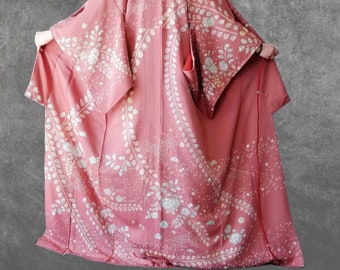 May include: A pink kimono with a white floral pattern. The kimono is made of a soft, silky fabric and has a traditional Japanese design.