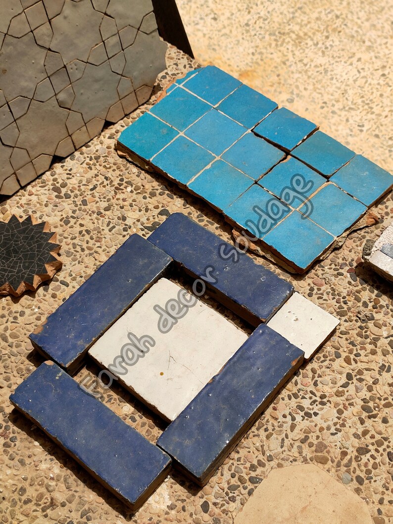 May include: Assortment of blue, white, and gray ceramic tiles with geometric patterns. The tiles are arranged in a square shape and are ready to be used for a home decor project.