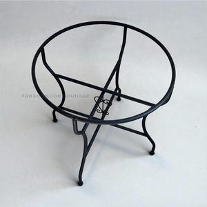 May include: Black metal table base with a circular top and decorative scrollwork. The base has four legs and is designed to support a tabletop. The brand name "FARAH DECOR SOUDAGE" is visible on the base.