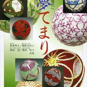 Pode incluir: Capa de livro com bolas Temari, um artesanato tradicional japonês. As bolas exibem intrincados desenhos geométricos em várias cores, incluindo vermelho, verde e branco. Texto japonês presente na capa.
