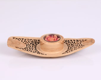 An Olive Wood Candle holder, with a unique lace perforation.