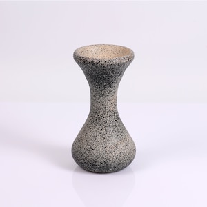 A stoneware look on a beautiful wood vase.