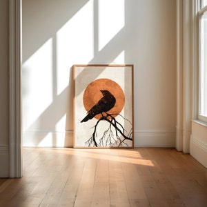 May include: A framed print of a black silhouette of a bird perched on a branch with a large orange sun behind it.