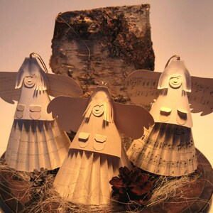 Handmade charming Christmas angels made from wove paper in decorative gift box,