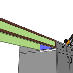 May include: A close-up of a mitre saw with a black and silver blade, resting on a workbench with drawers. The saw is positioned under a wooden shelf with a green and brown trim.