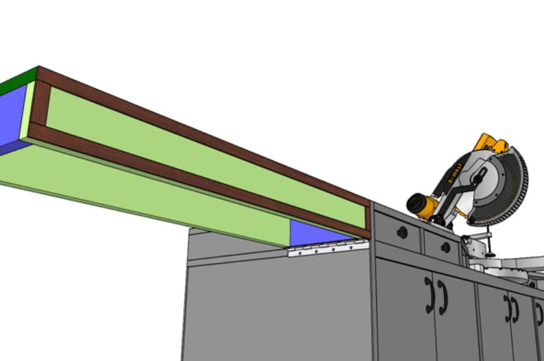 May include: A close-up of a mitre saw with a black and silver blade, resting on a workbench with drawers. The saw is positioned under a wooden shelf with a green and brown trim.