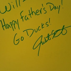 May include: A yellow card with green writing that says "Will - Happy Father's Day! Go Ducks!" and a signature that says "Just B".
