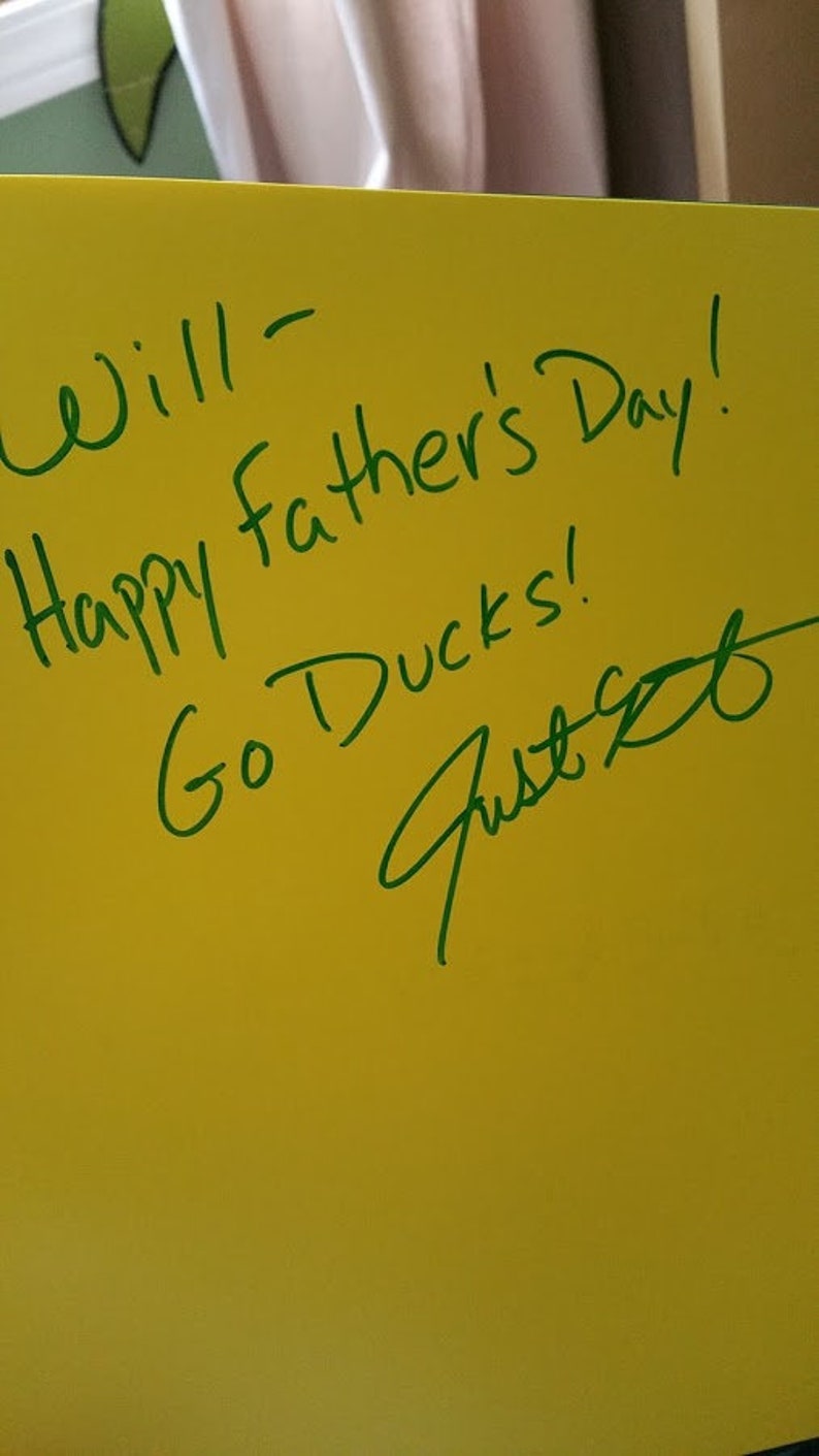 May include: A yellow card with green writing that says "Will - Happy Father's Day! Go Ducks!" and a signature that says "Just B".