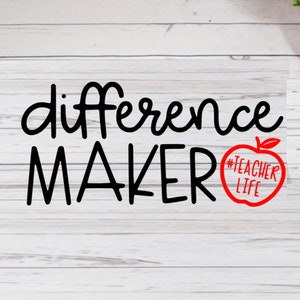 May include: Black and white text on a white wood background that reads "difference maker" with a red apple graphic that says "#teacherlife" in the center.