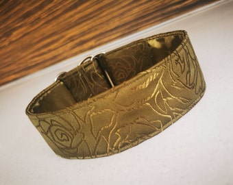 May include: A green dog collar with a rose pattern. The collar is made of a soft, satin-like material and has a silver buckle.
