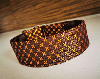May include: A brown and orange patterned dog collar with a silver buckle.