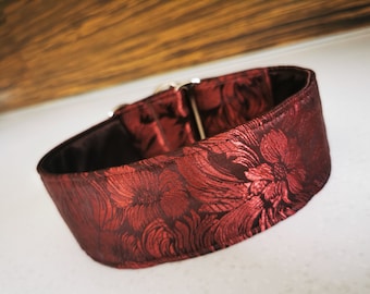 Puede incluir: Un collar de perro rojo con estampado floral y hebilla plateada.