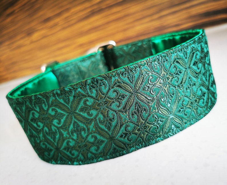 May include: A green patterned dog collar with a satin finish. The collar has a detailed, intricate design.