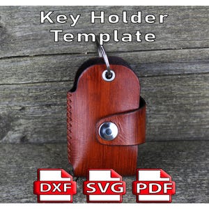 May include: A brown leather key holder with a metal ring and snap closure. The key holder has a stitched edge and a strap that secures with a silver snap. The text "Key Holder Template" is at the top, with DXF, SVG, and PDF icons below.