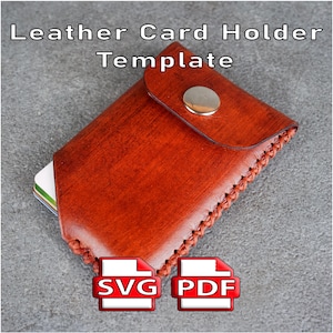 May include: A brown leather card holder with a silver metal snap button closure and visible stitched edges. The text 'Leather Card Holder Template' appears at the top, with 'SVG' and 'PDF' icons at the bottom. Several cards are visible inside.