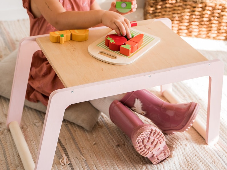 small children table with pink legs girl sitting on the desk