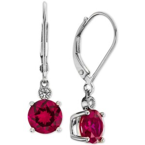May include: Silver dangle earrings with a red gemstone and a smaller clear gemstone. The earrings have a lever back closure.