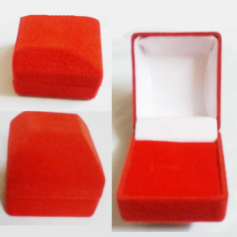 May include: A red velvet ring box, closed and open, against a white background. The closed box is a square shape with rounded edges. The open box reveals a white interior and a slot for a ring.