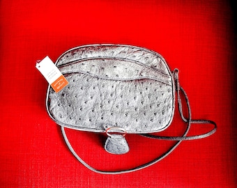 Bolsa transversal em couro de avestruz cinza, importada da África do Sul.