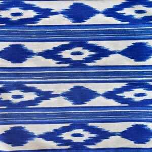 K&ouml;nnte beinhalten: Blauer und wei&szlig;er Ikat-Stoff mit einem sich wiederholenden geometrischen Muster.