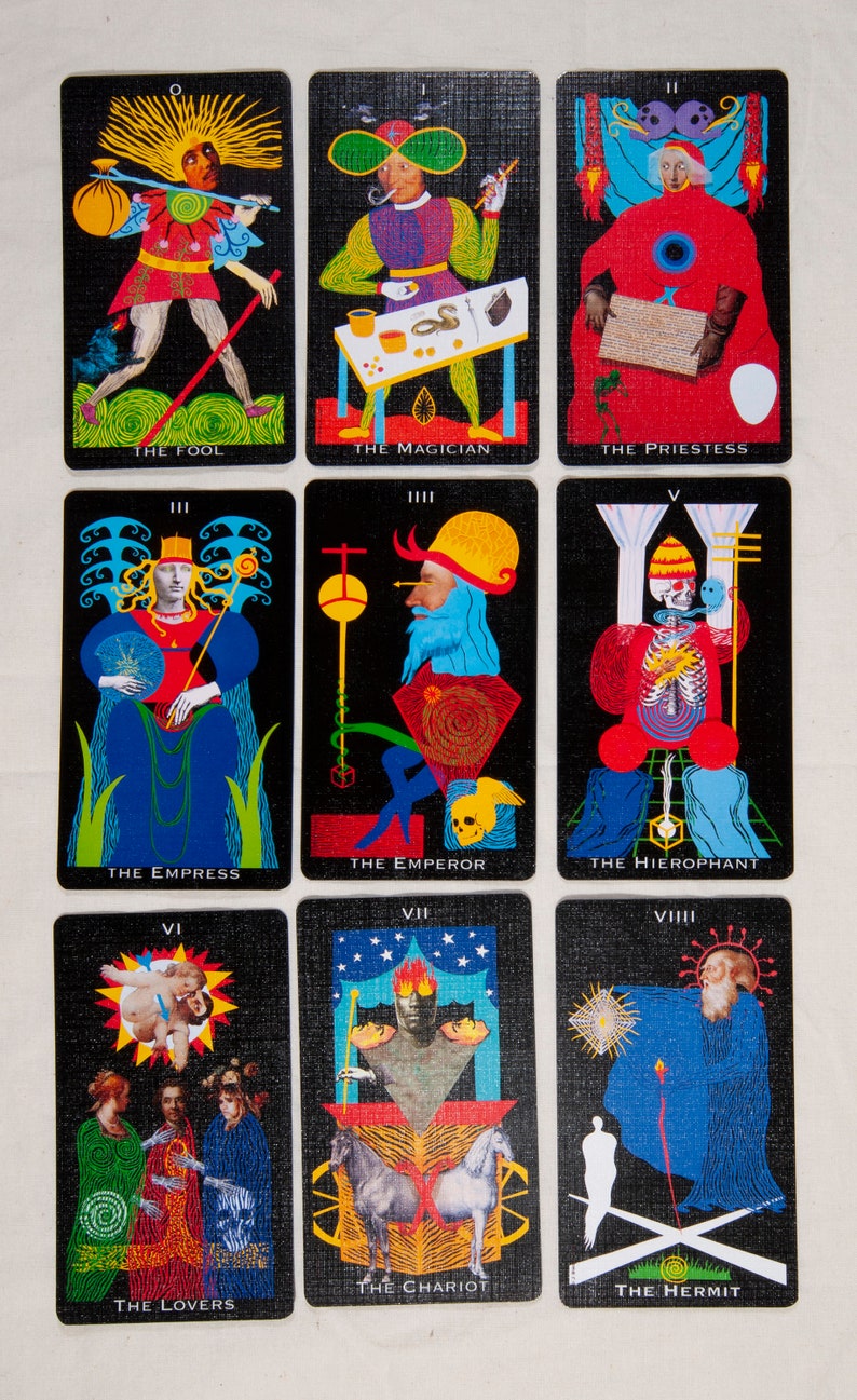 Puede incluir: Un juego de cartas de tarot con fondos negros e ilustraciones coloridas. Las cartas est&aacute;n numeradas del 0 al 9 y presentan im&aacute;genes del Loco, el Mago, la Sacerdotisa, la Emperatriz, el Emperador, el Hierofante, los Enamorados, el Carro y el Ermita&ntilde;o.