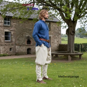 May include: A person wearing a blue long-sleeve shirt, a brown leather belt, and off-white cotton canvas pants with pockets. The pants have a unique, historical design. The text on the image reads "HERMOD - Cotton Canvas Pants S - 10XL - With Pockets".