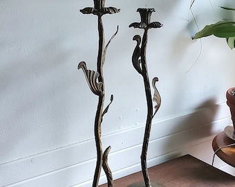 Two large candlesticks in worked metal flowers