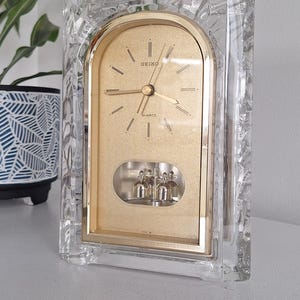 May include: A handmade wooden sign saying "Welcome to our home" in a handwritten style. The sign is painted white with a distressed finish and a black border. A small heart decoration is attached.