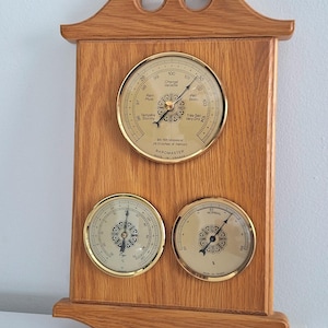 May include: A set of three ceramic mugs with a speckled, matte finish. The mugs are in shades of cream, light gray, and dark gray. Each mug has a simple, minimalist design, perfect for coffee or tea.