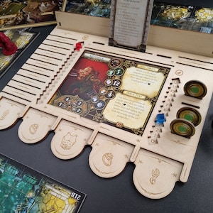 May include: A wooden game organizer with slots for tokens, cards, and dice. The organizer has a light wood finish and features a printed image of a character from a fantasy game. The character is a dwarf with a red beard and a red and gold outfit. The character is holding a hammer and a shield. The organizer has a slot for a character card, a slot for a power card, and a slot for a token. The organizer also has a slot for a dice tower.