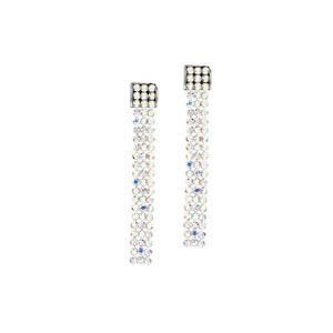 May include: A pair of long, silver dangle earrings with clear crystal stones. The earrings are made of a series of small, square-shaped stones that are connected together.