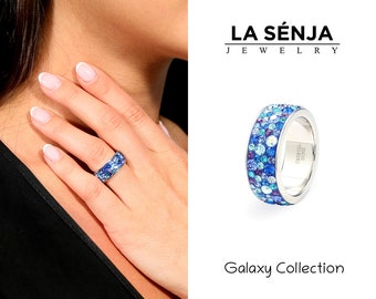 May include: A silver ring with a blue and purple crystal design. The ring is part of the Galaxy Collection by La Senja Jewelry.