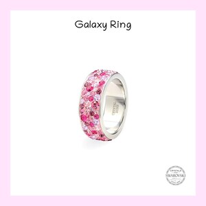 May include: A silver ring with a band of pink, purple, and red crystals. The ring is engraved with "CRYSTAL ZONE".