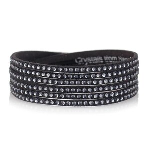 May include: A black leather bracelet with multiple rows of sparkling black crystals. The bracelet has the text "Crystals from Swarovski" on the leather.