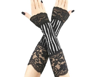 May include: Black and white striped fingerless gloves with black lace trim. The gloves have a gothic aesthetic, with a striped pattern on the arm and delicate lace detailing at the wrist and upper arm.