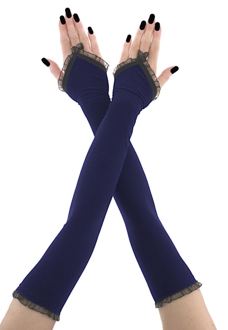 Handmade elegant long evening gloves in deep navy blue. These formal opera length fingerless sleeves are decorated with ruffled black lace trim and feature a secure finger loop design. Perfect sophisticated accessory for formal gowns, prom, gala parties, or alternative weddings. Crafted from high quality stretchy fabric that fits beautifully along the arm, adding a dramatic, luxurious, and gothic Victorian touch to any evening outfit.