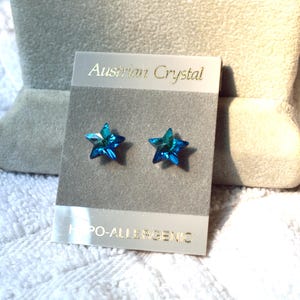 May include: A pair of blue star-shaped earrings on a white card with the text "Austrian Crystal" and "Hypo-allergenic".