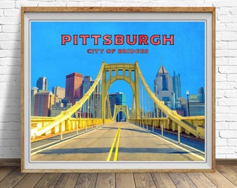 May include: A framed print featuring a vibrant image of a yellow bridge in Pittsburgh, Pennsylvania, with the city skyline in the background. The text "PITTSBURGH CITY OF BRIDGES" is displayed at the top against a clear blue sky.