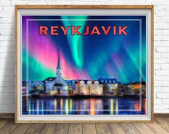 May include: Framed print featuring the word "REYKJAVIK" in red letters above a cityscape. The image shows a church with a tall steeple, buildings, and a body of water reflecting the colorful sky of the aurora borealis.