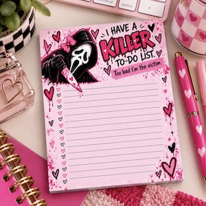 May include: A rectangular notepad with a light pink background featuring a hooded figure in a white mask holding a knife. The text reads I HAVE A KILLER TO-DO LIST. Too bad I'm the victim. The page includes lined sections with heart-shaped checkboxes.