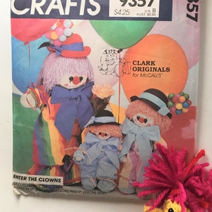 May include: A vintage sewing pattern for making three clown dolls. The pattern is for a 17-inch, 13-inch, and 9-inch doll. The pattern is titled "Enter the Clowns" and features a colorful illustration of the three dolls.