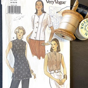 May include: A vintage sewing pattern titled "Very Easy Very Vogue" with illustrations of women's tops. The pattern includes sizes 14-16-18. Spools of thread in black, white, and yellow are in the background.