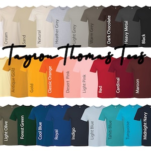 May include: A color chart of t-shirt colors. The chart shows 28 different colors of t-shirts, including white, cream, sand, natural, heather grey, light grey, warm grey, dark chocolate, heavy metal, black, banana cream, antique gold, gold, classic orange, desert pink, light pink, red, cardinal, maroon, kelly green, military green, light olive, forest green, cool blue, royal, indigo, light blue, tahiti blue, turquoise, midnight navy, and purple rush.