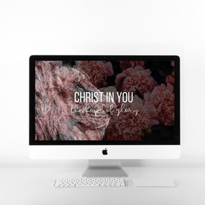 May include: A white desktop computer with a black screen displaying a floral background with the text "CHRIST IN YOU the hope of glory".