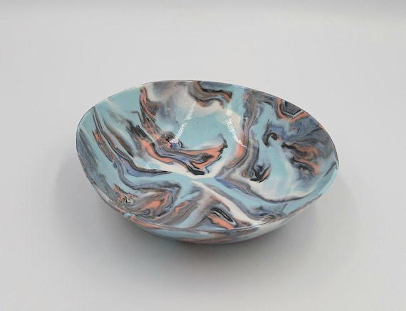 Nerikomi is a rare Japanese technique of layering colored porcelain clays to create marble-like patterns sliced through the body — genuinely few makers do this well.