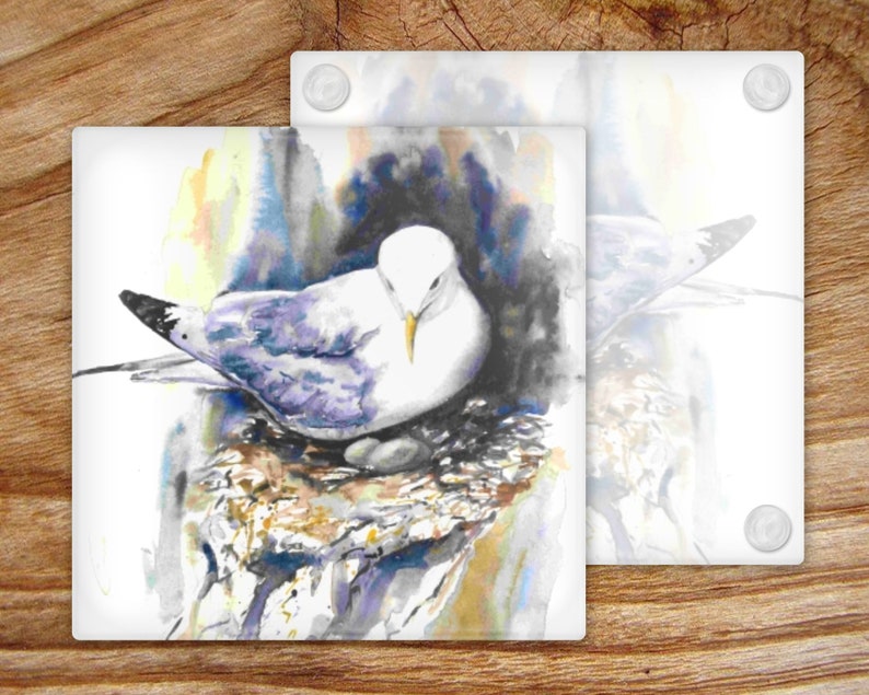 May include: A watercolor painting of a white seagull with purple and blue feathers sitting on a nest made of twigs and branches. The background is a soft watercolor wash of yellow, blue, and gray.
