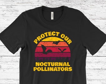 May include: Black t-shirt with a vintage-style sunset graphic and the text "Protect Our Nocturnal Pollinators". The graphic features three bats flying in front of the sunset.