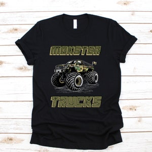 May include: Black t-shirt with a green camouflage monster truck graphic and the text "MONSTER TRUCKS".