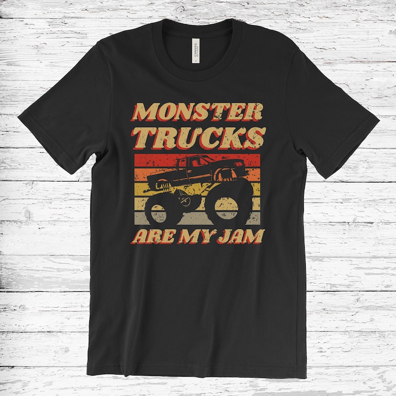 May include: Black t-shirt with a vintage-style graphic of a monster truck. The graphic features a red monster truck with large tires and the text "Monster Trucks Are My Jam".
